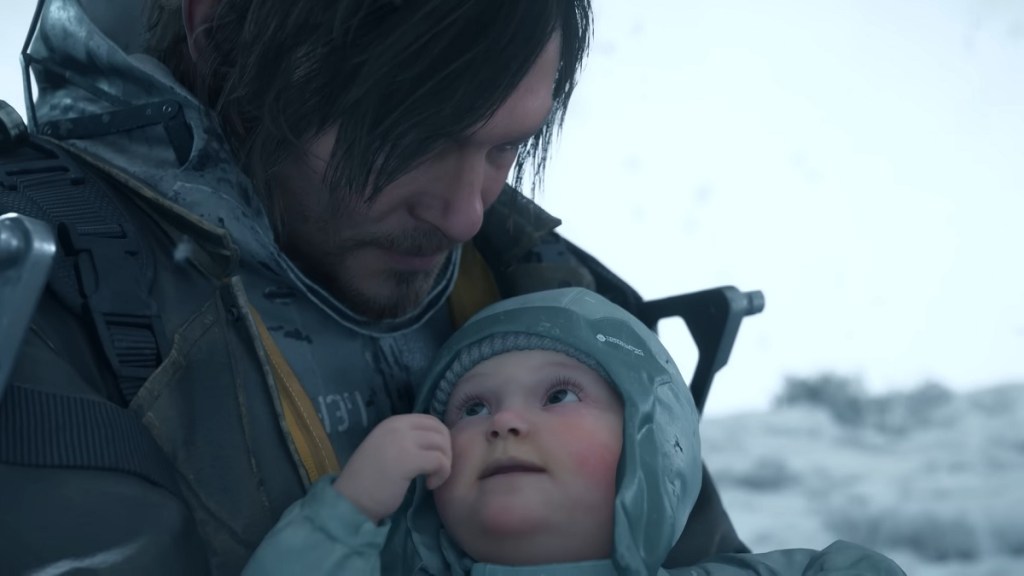 Death Stranding 2: Sam Porter Bridges holding a baby close to his face.