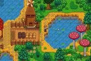 Stardew Valley: a character is fishing in a small lake behind a mill.